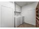 Functional laundry room with a washer, dryer, cabinets, and shelving at 2809 Mason Ave, Las Vegas, NV 89102