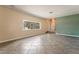 Bright living room featuring neutral tones, tiled flooring, and large window at 2809 Mason Ave, Las Vegas, NV 89102