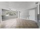 Open-concept living room with tile floors, multiple windows, and two ceiling fans at 2809 Mason Ave, Las Vegas, NV 89102