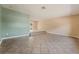 Open living room with tile flooring, neutral paint, and a stepped platform area at 2809 Mason Ave, Las Vegas, NV 89102