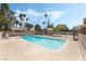 Refreshing in-ground pool with clear water, palm trees, and spacious deck area at 2809 Mason Ave, Las Vegas, NV 89102