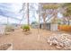 Expansive backyard with desert landscaping, a storage shed, and mature trees for shade at 2819 Taylor Ave, North Las Vegas, NV 89030