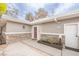The house boasts a charming front entrance with a red door, stone accents, and a well-manicured planter at 2819 Taylor Ave, North Las Vegas, NV 89030