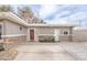 The house features a red door, stone accents, a tidy yard, and a concrete driveway leading to the entrance at 2819 Taylor Ave, North Las Vegas, NV 89030