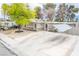 This single-story home features stone accents, mature trees, and a convenient covered parking area in the front yard at 2819 Taylor Ave, North Las Vegas, NV 89030