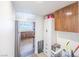 Bright hallway leads to kitchen and features storage cabinets and a stainless steel refrigerator at 2819 Taylor Ave, North Las Vegas, NV 89030