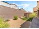 A gravel backyard with green grass and a fire pit at 2964 Gunnery Forge St, Las Vegas, NV 89156