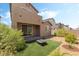 Exterior of a home featuring a grass patch with a fire pit, gravel, and desert landscaping at 2964 Gunnery Forge St, Las Vegas, NV 89156