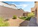 Beautiful backyard featuring a low-maintenance design with gravel, artificial turf, and a decorative brick wall at 2964 Gunnery Forge St, Las Vegas, NV 89156