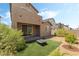 Enclosed backyard featuring artificial turf, a fire pit, and a sliding glass door to the home's interior at 2964 Gunnery Forge St, Las Vegas, NV 89156