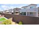 View of home's backyards featuring block wall fences, desert landscaping, and small patches of grass at 2964 Gunnery Forge St, Las Vegas, NV 89156