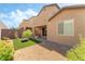 Backyard with pavers, gravel, turf, and small plants, along with a covered patio and seating area at 2964 Gunnery Forge St, Las Vegas, NV 89156
