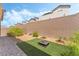 View of a backyard featuring a fire pit, gravel, and green grass at 2964 Gunnery Forge St, Las Vegas, NV 89156