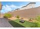 Landscaped backyard with stone pavers, decorative gravel, and an artificial turf area with a fire pit at 2964 Gunnery Forge St, Las Vegas, NV 89156