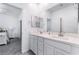 Bright bathroom with dual sinks, modern fixtures, and view to the bedroom at 2964 Gunnery Forge St, Las Vegas, NV 89156