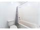 Clean bathroom with a white toilet and a bathtub with a white tiled enclosure at 2964 Gunnery Forge St, Las Vegas, NV 89156