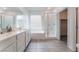 Modern bathroom with a shower, tub, and a double sink vanity with white cabinets at 2964 Gunnery Forge St, Las Vegas, NV 89156