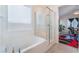 Clean bathroom with a soaking tub and glass-enclosed shower, offering a bright and modern space at 2964 Gunnery Forge St, Las Vegas, NV 89156