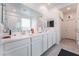 Bright bathroom featuring dual sinks, white cabinetry, and a shower with glass door at 2964 Gunnery Forge St, Las Vegas, NV 89156