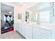 Bathroom view showing a double vanity with white cabinets and a full mirror, creating a clean and spacious feel at 2964 Gunnery Forge St, Las Vegas, NV 89156
