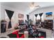 Spacious bedroom with gaming chairs and ceiling fan at 2964 Gunnery Forge St, Las Vegas, NV 89156