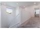 This bright hallway offers carpet flooring and a window with natural light at 2964 Gunnery Forge St, Las Vegas, NV 89156