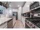 Modern kitchen featuring stainless steel appliances, granite countertops, and white cabinetry at 2964 Gunnery Forge St, Las Vegas, NV 89156