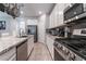 Modern kitchen featuring stainless steel appliances, granite countertops and white cabinets at 2964 Gunnery Forge St, Las Vegas, NV 89156