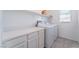 Functional laundry room with white cabinets, countertop space, and side by side washer and dryer at 2964 Gunnery Forge St, Las Vegas, NV 89156