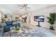 Open-concept living room that flows to dining area, and includes a modern ceiling fan at 2964 Gunnery Forge St, Las Vegas, NV 89156