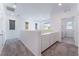 Open loft area with carpet flooring and a built-in desk with white cabinets at 2964 Gunnery Forge St, Las Vegas, NV 89156