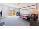 Bedroom featuring a four-poster bed, desk, and sliding doors leading to a balcony with lots of natural light at 2964 Gunnery Forge St, Las Vegas, NV 89156