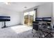 Open office area with desk setup, TV and sliding glass door to balcony at 2964 Gunnery Forge St, Las Vegas, NV 89156