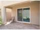 A covered patio with a chair, a sliding glass door and brick pavers at 2964 Gunnery Forge St, Las Vegas, NV 89156