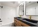 Modern bathroom featuring a sleek double sink vanity with stylish fixtures and a shower over tub at 3260 Longford Way, Las Vegas, NV 89121