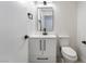 Well-lit half bathroom features modern fixtures and a sleek, minimalist design at 3260 Longford Way, Las Vegas, NV 89121