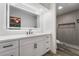 Modern bathroom features an illuminated mirror, stylish vanity, and walk-in shower at 3260 Longford Way, Las Vegas, NV 89121