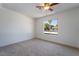 Bedroom featuring neutral carpeting and a window with a view of a palm tree at 3260 Longford Way, Las Vegas, NV 89121