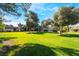 Well-maintained grassy common area with mature trees adding to the curb appeal at 3260 Longford Way, Las Vegas, NV 89121