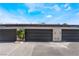 A row of garages under a blue sky features a well-kept exterior at 3260 Longford Way, Las Vegas, NV 89121