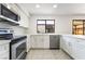 Updated kitchen featuring stainless steel appliances, quartz counters, and bright white cabinets at 3260 Longford Way, Las Vegas, NV 89121