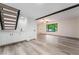 Open living space features a staircase, wet bar, and bright natural light at 3260 Longford Way, Las Vegas, NV 89121
