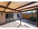 Enclosed outdoor patio features a mix of stone and wood surfaces, with a pergola providing shade at 3260 Longford Way, Las Vegas, NV 89121