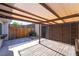 Enclosed outdoor patio features a mix of stone and wood surfaces, with a pergola providing shade at 3260 Longford Way, Las Vegas, NV 89121