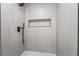 Updated shower with gray tile, matte black fixtures, and recessed shelf at 3260 Longford Way, Las Vegas, NV 89121