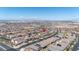 Expansive aerial view of a residential neighborhood with stunning city skyline in the distance and mountain views under a blue sky at 329 Brockbank Pl, Henderson, NV 89011