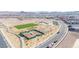 Aerial shot of community park with tennis courts, grassy fields, and shaded picnic areas at 329 Brockbank Pl, Henderson, NV 89011
