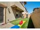 Turf backyard with patio, block wall, and playset at 329 Brockbank Pl, Henderson, NV 89011