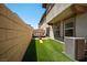 Turf backyard with patio furniture, block wall, and AC unit at 329 Brockbank Pl, Henderson, NV 89011