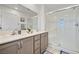 Elegant bathroom featuring a double sink vanity and a glass-enclosed shower at 329 Brockbank Pl, Henderson, NV 89011